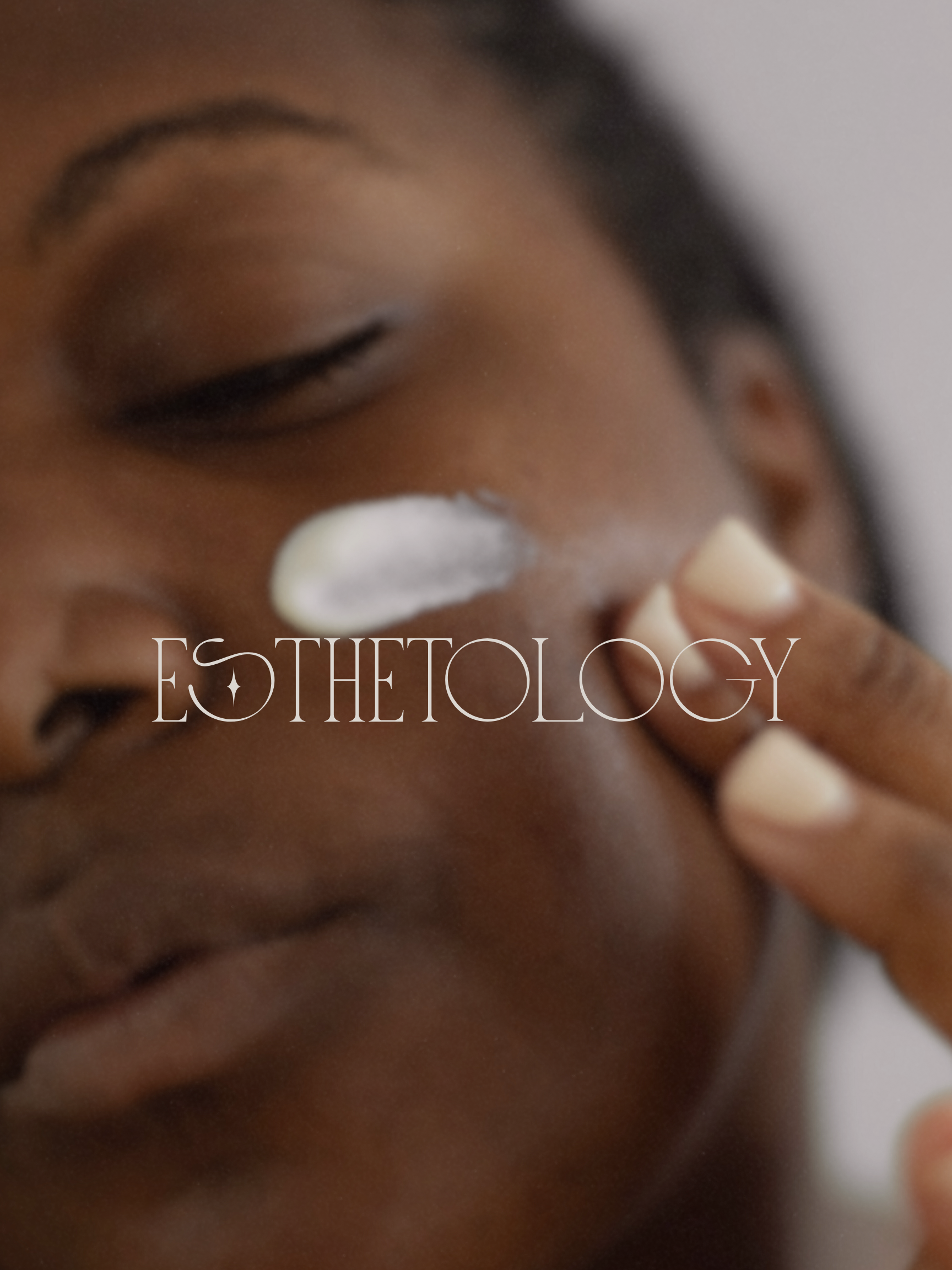Person applying cream to face with 'Esthetology' branding